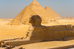 A-side-view-of-the-great-Sphinx-with-all-of-the-pyramids-of-Giza-in-the-background-in-Cairo-Egypt