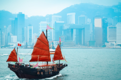 orange-wooden-sailboat-sailing-in-victoria-harbor-at-Hong-Kong